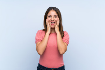 Young brunette girl over isolated blue background with surprise facial expression