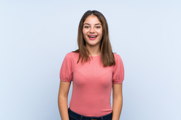 Young brunette girl over isolated blue background with surprise facial expression