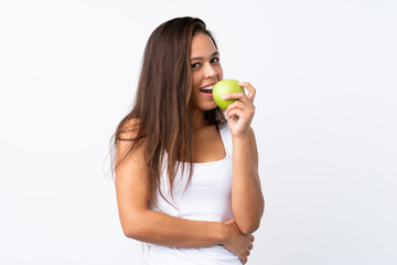 Young Brazilian girl with an apple over isolated background