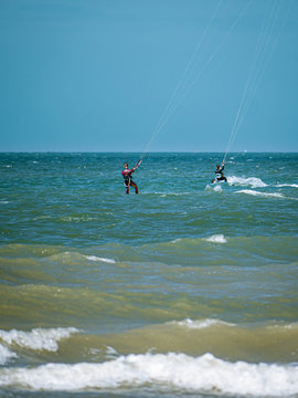 Two Kite Surfer from behind heading towards open seas