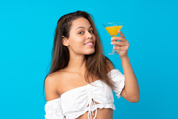Young woman in summer holidays over isolated blue background