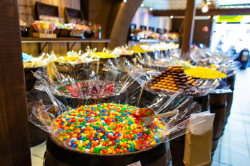 Confectionery shop in retro style. Colorful candies and sweets in wooden barrels.