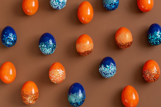 Beautiful Easter background with orange and blue decorative eggs.