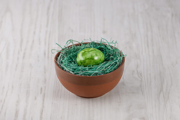 easter eggs in bowl on a wooden background