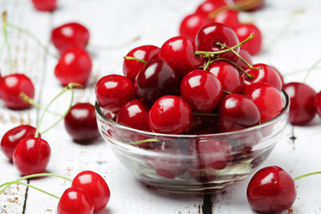 A small glass bowl with ripe fresh cherry