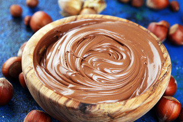 Homemade hazelnut spread in wooden bowl. Hazelnut Nougat cream with hazelnuts