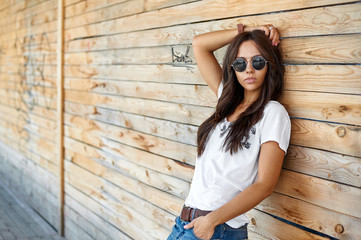 Outdoor street fashion portrait of stylish woman in sunglasses