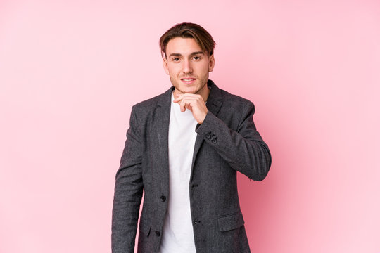 Young caucasian business man posing isolated smiling happy and confident, touching chin with hand.