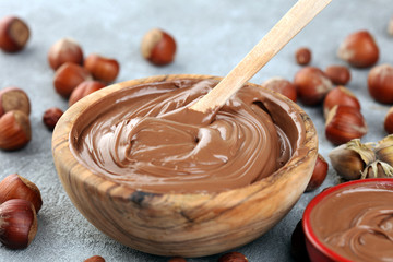 Homemade hazelnut spread in wooden bowl. Hazelnut Nougat cream with hazelnuts