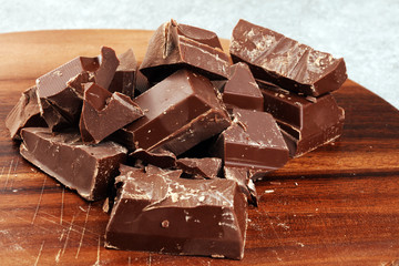 Dark chocolate stack, chips and powder with chocolate bars and block
