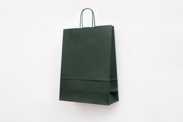 green paper bag with twisted handles