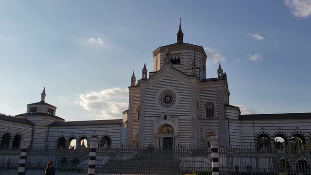 Milan, Italy - April, 2019 - Panning shot of the main entrance of Monumental Cemetery (Cimitero Monumentale di Milano).