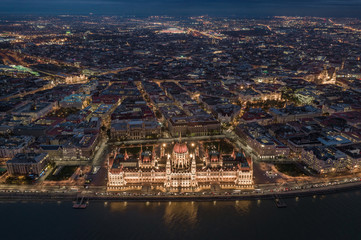 Budapest, Hungary - Aerial skyline view of Budapest by night. This view includes the illuminated Hungarian Parliament building, St. Stephen's Basilica, Nyugati Railway Station and the new Puskas Arena