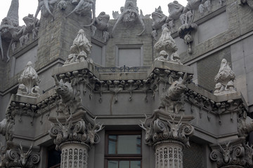 Capital and the upper part of the facade with sculptures of animals on the historic Art Nouveau building, called "House with Chimeras" (built in 1902), Kiev, Ukraine