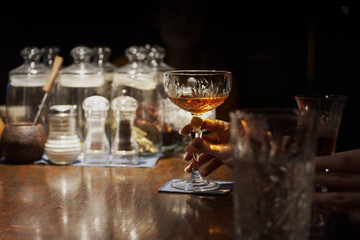 Glass with cocktail on desk