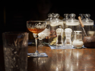 Glass with cocktail on desk