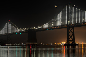 View of Half Moon Over the San Francisco Oakland Bridge at Night