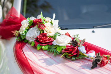 White wedding car decorated with fresh flowers. Wedding decorations.