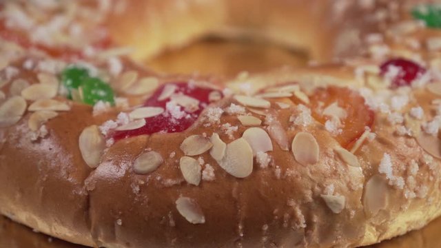 Traditional typical spanish round cake ROSCON KINGS with fruit and nuts close-up. Festive dessert. Camera track