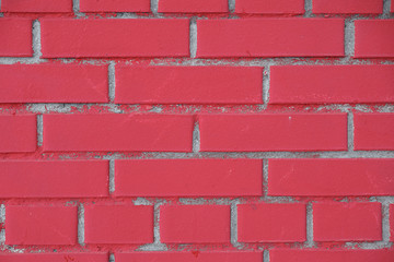 The red brick wall is close-up. Background of scarlet