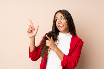 Young woman over isolated background pointing with the index finger a great idea