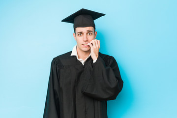 Young caucasian graduated man biting fingernails, nervous and very anxious.