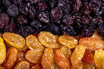 background of dark and light raisins. close up.dried grapes.