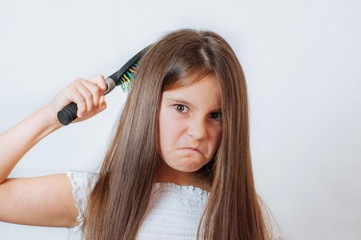 Caucasian little cute girl unhappy with very long hair, portrait