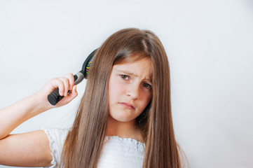Fototapeta premium Caucasian little cute girl unhappy with very long hair, portrait