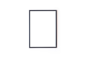 Blank black square frame in front of white wall 