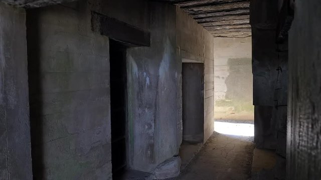 Interior of German bunker ruins in Atlantic wall, Longues sur Mer, Normandy, France. Slow reveal