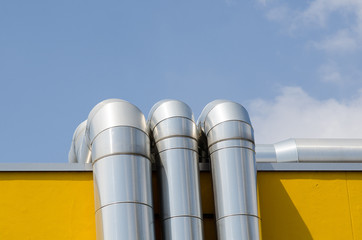 heating system or utility lines on a building. The pipes of the service system on the roof are covered with a galvanized steel cover.