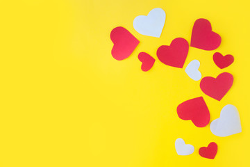 Valentine's Day background. Red hearts on yellow background. Valentines day concept. Flat lay, top view, copy space