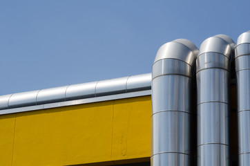 heating system or utility lines on a building. The pipes of the service system on the roof are...