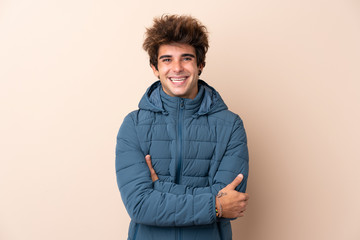 Man wearing winter jacket over isolated background smiling a lot