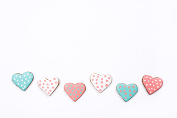 Gingerbread cookies with frosting in the shape of a heart on white background. Valentines day concept. Flat lay, top view, copy space for text.