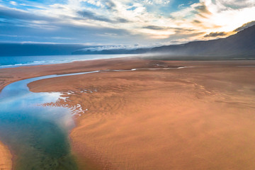 Fototapeta na wymiar Aerial drone view of icelandic Raudasandur beach with azure water streams and yellow sand