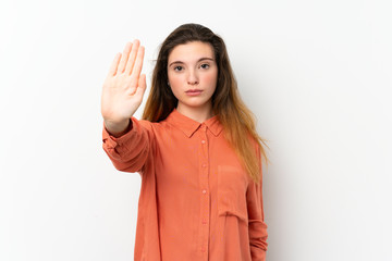Young brunette girl over isolated white background making stop gesture