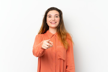 Young brunette girl over isolated white background surprised and pointing front