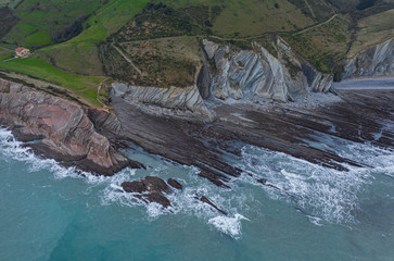 Zumaia and Algorri flysch geological strata layers drone aerial view panorama, Basque Country