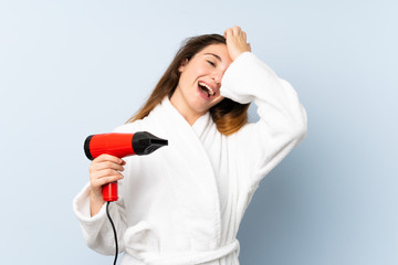 Young woman in a bathrobe with hair hairdryer has realized something and intending the solution