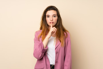 Young brunette girl with blazer over isolated background showing a sign of silence gesture putting finger in mouth