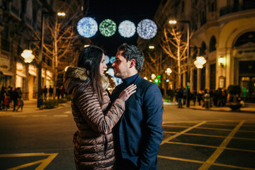 Fototapeta na wymiar Couple in love in the city christmas