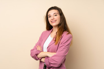 Obraz premium Young brunette girl with blazer over isolated background with arms crossed and looking forward