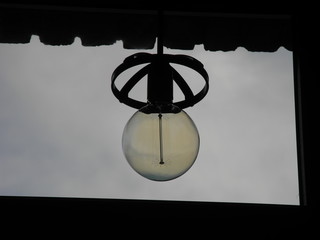 Macro of a LED lamp that weighs on the ceiling near the window