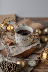 cup of coffee with cookies and cinnamon sticks