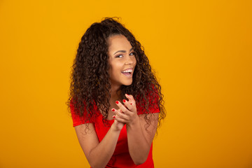 Young pretty afro woman feeling happy and successful, smiling and clapping hands, saying congratulations with an applause