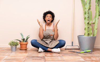Gardener woman sitting on the floor frustrated by a bad situation