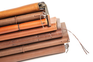 A Stack Of Leather-Bound Journals, Notebooks, Wallets & Cases