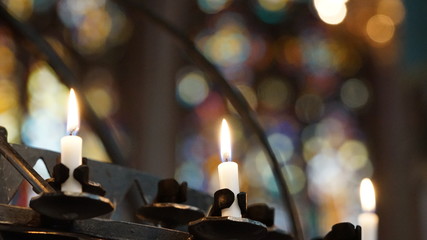 Flickering candles lit in old church